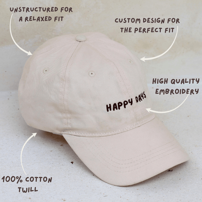 Women's mid-profile 100% cotton dad style cap in cream with Happy days with information about the details of the cap
