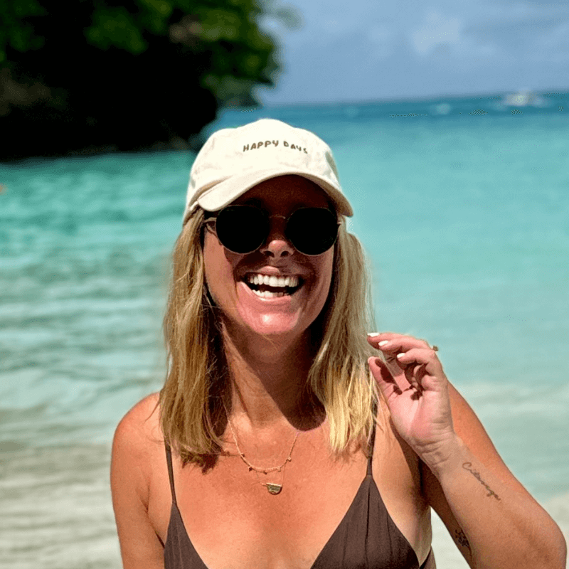 Woman wearing mid-profile relaxed 100% cotton cap at the beach Australia