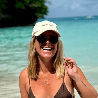 Woman wearing mid-profile relaxed 100% cotton cap at the beach Australia